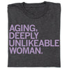 Charcoal t-shirt featuring the lavender text: AGING, DEEPLY UNLIKEABLE WOMAN.