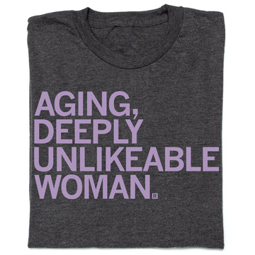 Charcoal t-shirt featuring the lavender text: AGING, DEEPLY UNLIKEABLE WOMAN.