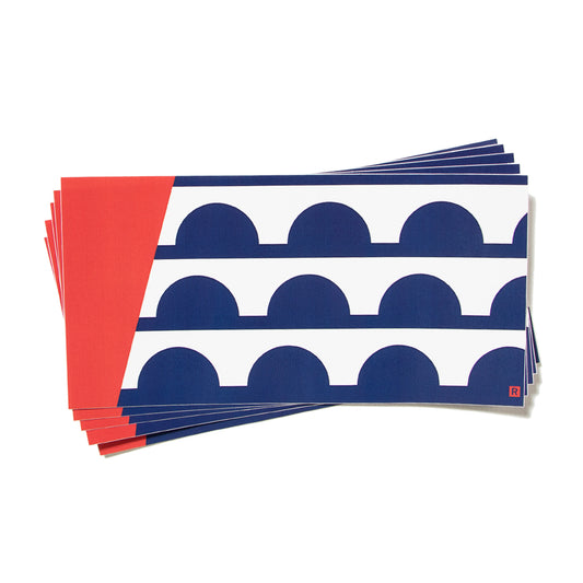 A stack of Des Moines flag rectangular cards featuring a pattern of blue semicircles on a white background with a solid red border on the left.