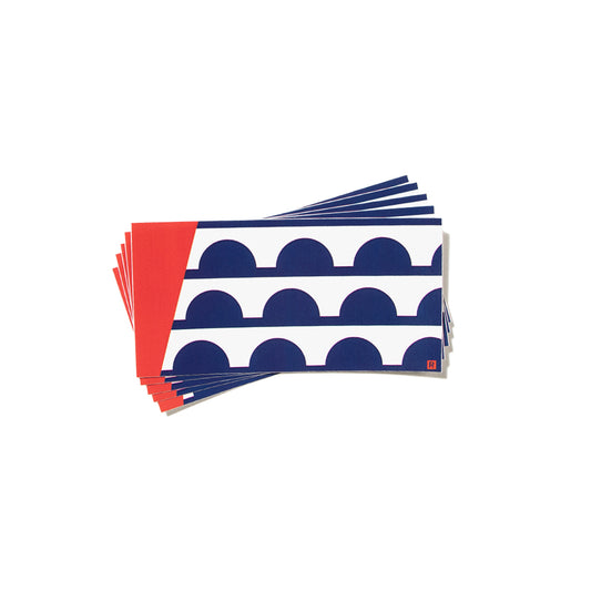 A stack of Des Moines IA flag vinyl stickers, each featuring a rectangular design with a red left edge and a pattern of blue semi-circles on a white background.