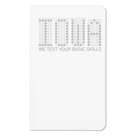 A notebook cover featuring the word DUMB formed by multiple-choice bubbles, with the text WE TEST YOUR BASIC SKILLS underneath, manufactured by Iowa Union Labor.