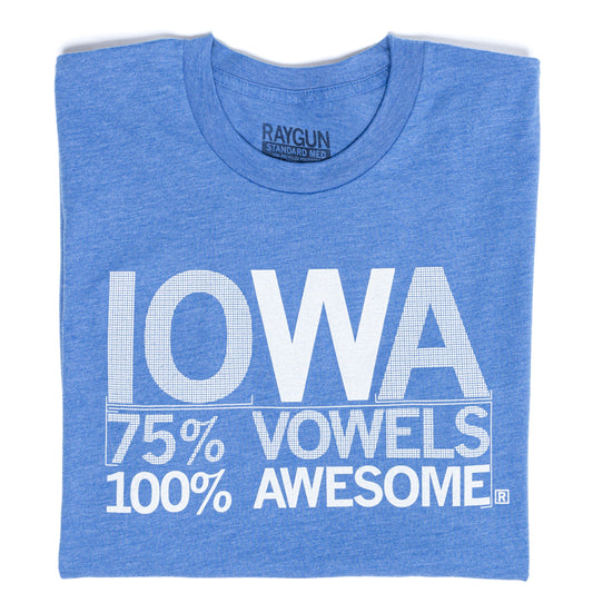 A folded heather blue shirt with centered white ink that says, "Iowa: 75% Vowels, 100% Awesome!" in all caps.