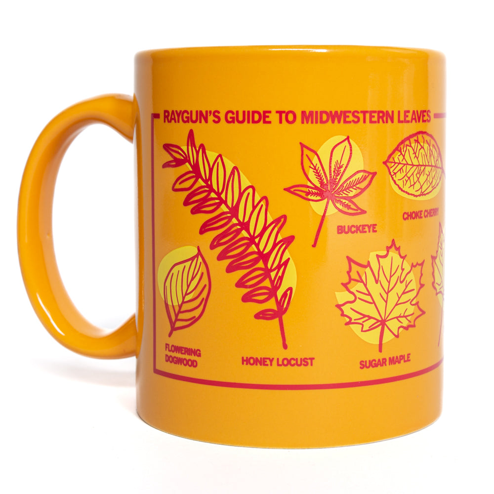 Mustard yellow 11 oz RAYGUN mug printed with Rayguns Guide to Midwestern Leaves and illustrations of various leaf types with their names.