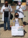 Three people in face masks and casual clothing, including a Nasty Women T-shirt, hold signs that read FACE THE TRUTH: DOCTORS FOR BIDEN, with one person holding an additional sign that says #Doctors FOR BIDEN/HARRIS.