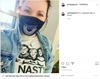 A woman wears a face mask saying VOTE above a judicial collar and a Nasty Women t-shirt featuring illustrations of Ruth Bader Ginsburg, Sonia Sotomayor, and Elena Kagan above the word NASTY.