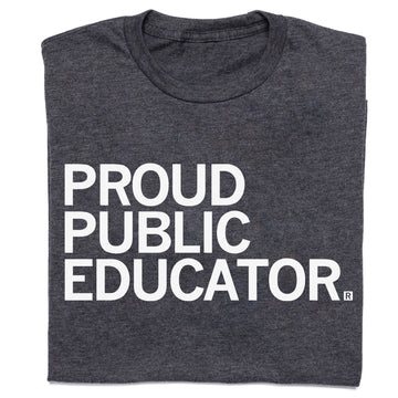 A folded charcoal t-shirt with white text that reads "Proud Public Educator"