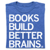 A folded heather royal blue shirt with all caps white print that reads "Book Build Better Brains."
