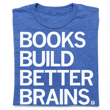 A folded heather royal blue shirt with all caps white print that reads "Book Build Better Brains."