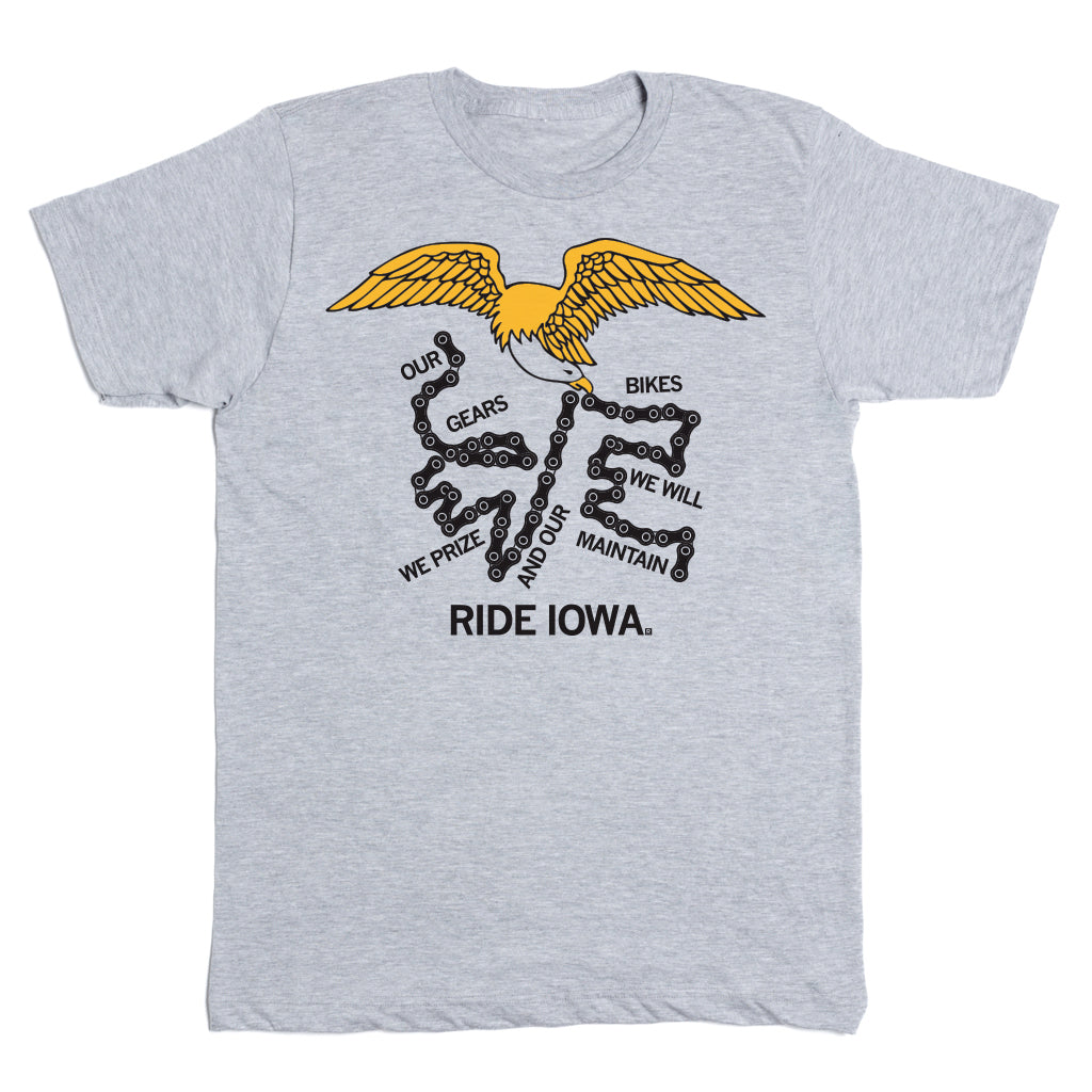 Grey RAYGUN t-shirt featuring an eagle above bicycle chain links arranged to spell OUR GEARS WE WILL MAINTAIN and WE PRIZE AND OUR BIKES, with the text RIDE IOWA at the bottom.
