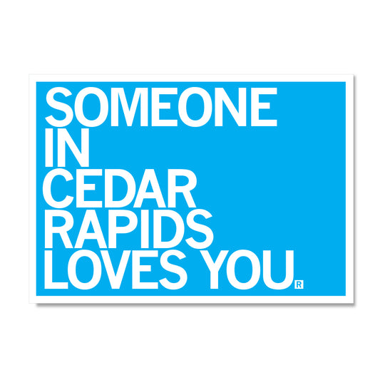 Blue RAYGUN sign with white text that reads, SOMEONE IN CEDAR RAPIDS LOVES YOU.