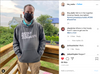 A man stands on a wooden deck wearing a black Pigment Black Pullover Hoodie that says AMERICA NEEDS JOURNALISTS and a black face mask that says Facts First.