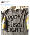 A heather grey Busch Light t-shirt printed with the text BODY BY BUSCH LIGHT, flanked by two cans of beer.