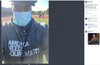 A man wearing a blue face mask, a flat cap, and an America Needs Journalists pigment black pullover hoodie stands on a track field.