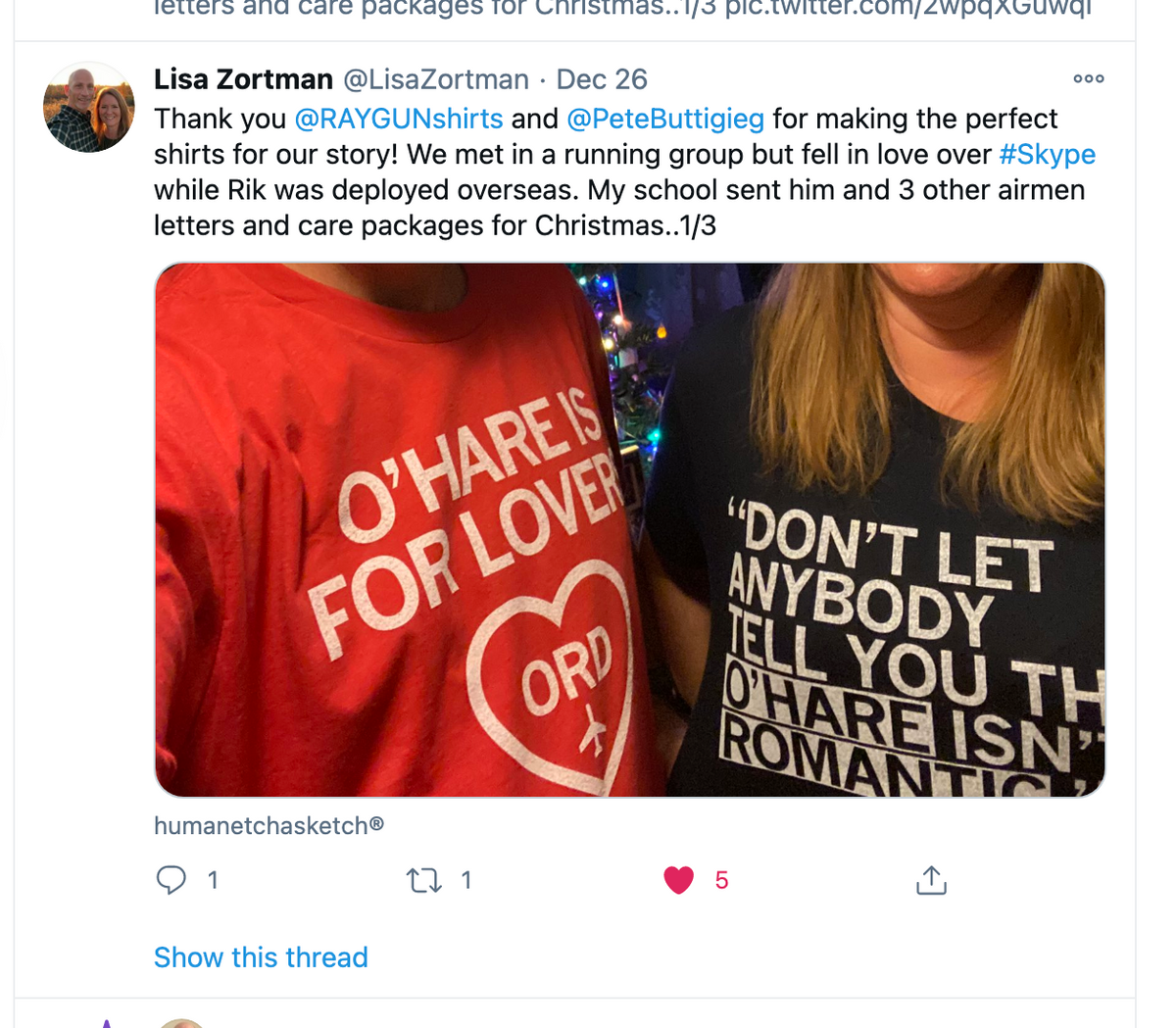 Two people wear black and red RAYGUN t-shirts featuring white text that references O’Hare International Airport and romance.
