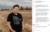 A person with a short haircut stands in a field wearing a sweatshop-free black t-shirt printed with the words THEY. THEM. THEYRE. THERE. THEIR.