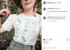 A person wearing a cream-colored, union-made t-shirt printed with a botanical guide to Midwestern leaves and their names.