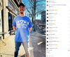 A man wearing a union labor blue t-shirt that says Get your own then tell it what to do with a graphic of a uterus stands on a sidewalk in front of a Planned Parenthood building.
