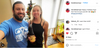 A man in a blue union labor t-shirt and a woman in a black top hold a bottle of cider in front of a Christmas tree as an orange cat sits nearby.