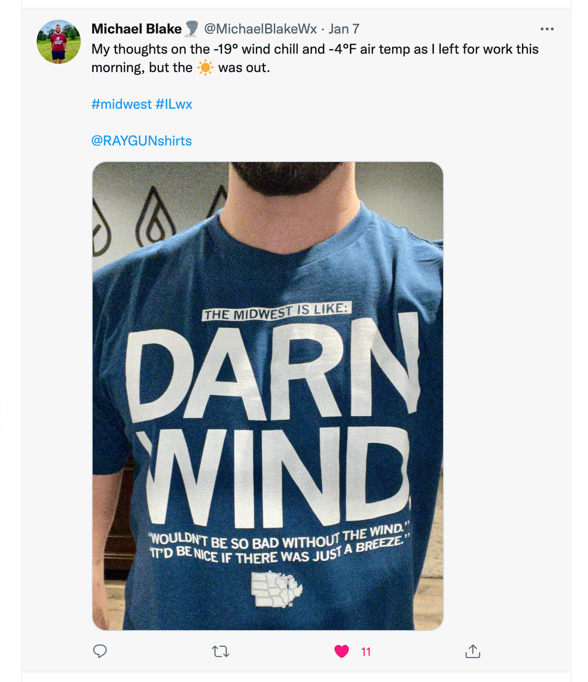 A person wearing a cool blue Midwest t-shirt printed with the text, The Midwest is like: Darn wind. Wouldn’t be so bad without the wind. It’d be nice if there was just a breeze, alongside an outline map of the Midwest states.