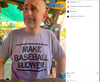 A man wearing a sweatshop-free grey t-shirt that says MAKE BASEBALL SLOWER.