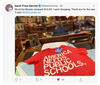 A red union-made t-shirt printed with AMERICA NEEDS PUBLIC SCHOOLS rests on a wooden desk inside a legislative chamber.