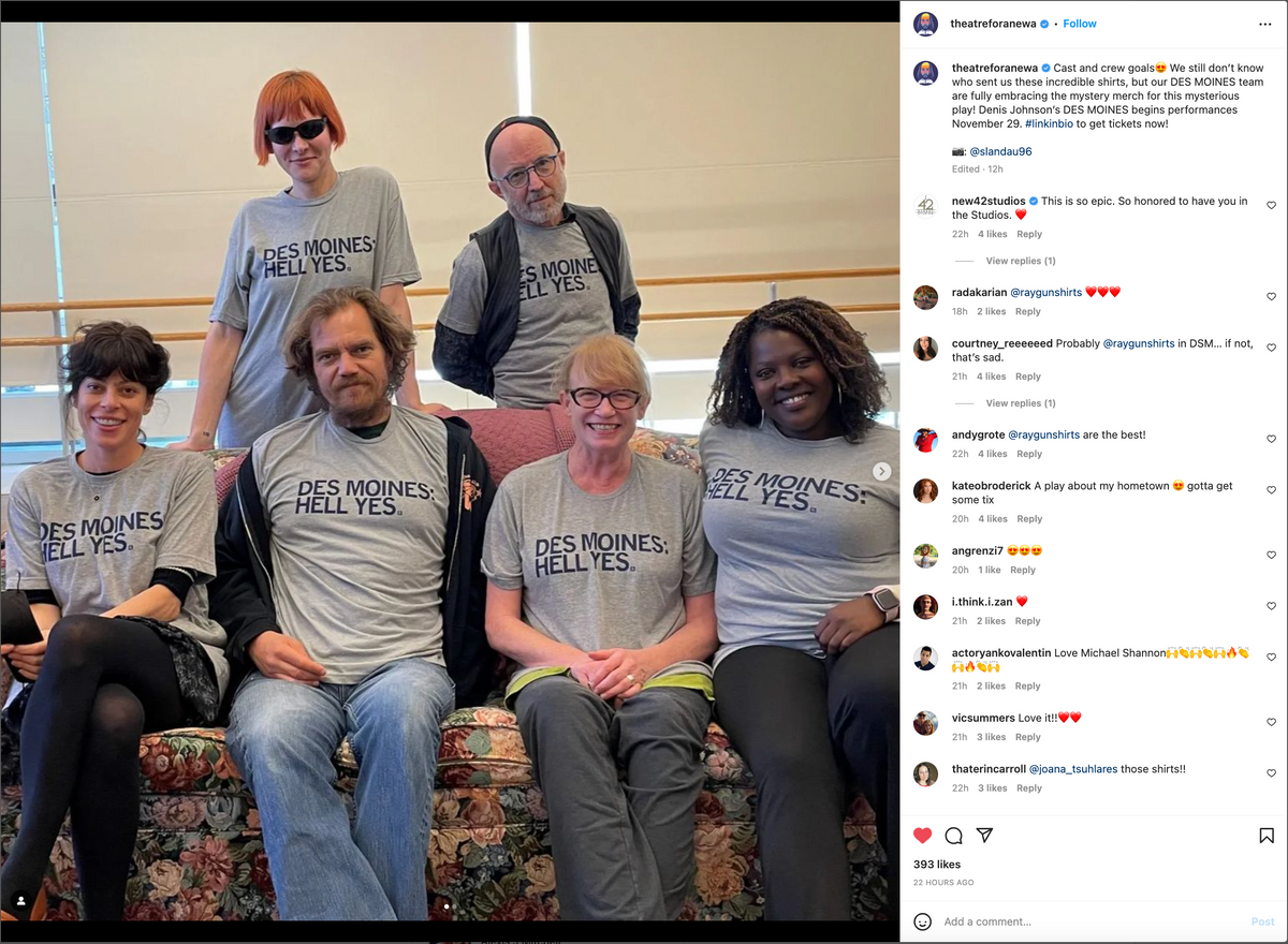 Six people in heather grey t-shirts that read DES MOINES: HELL YES stand or sit together.