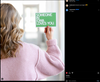 A person seen from behind holding a union printed green sign that reads, SOMEONE IN IOWA LOVES YOU.