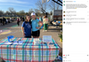 Two young women in union made, eco-friendly t-shirts stand behind a booth for an Iowa Environmental Council event, featuring a sign detailing plants for sale and donations.