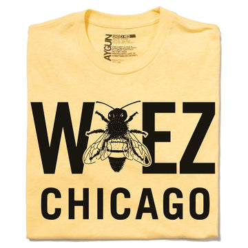 Yellow WBEZ merchandise t-shirt with WEEZ CHICAGO printed in black, featuring a bee graphic in place of the letter E.
