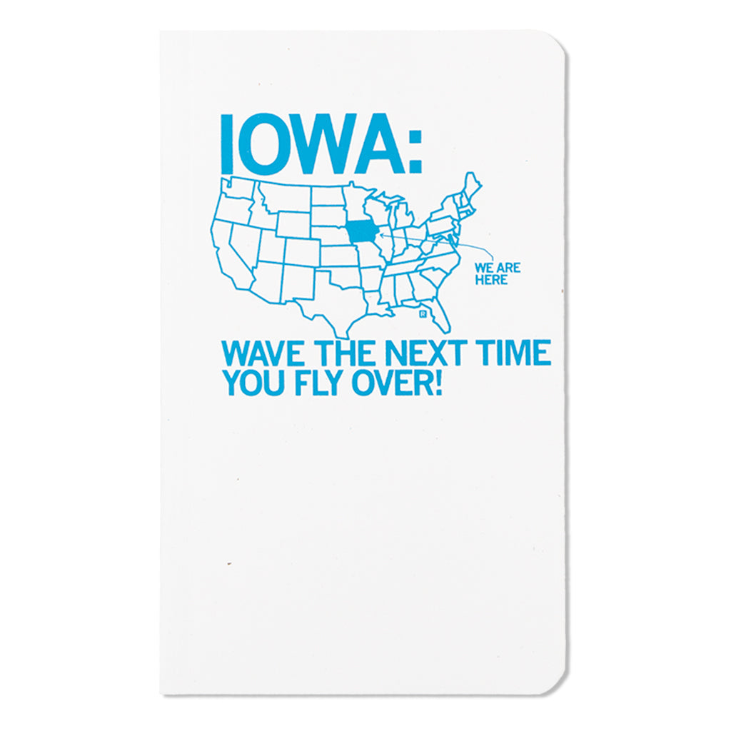 A screen-printed notebook cover featuring a blue map of the United States with Iowa highlighted, reading IOWA: WAVE THE NEXT TIME YOU FLY OVER! and pointing to Iowa with WE ARE HERE.