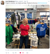 Kirsten Gillibrand stands in a store holding two bottles of ranch dressing, wearing a heather red t-shirt that reads America Needs Love above racks of clothing.