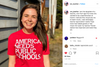A smiling woman wearing a union-made red t-shirt that says America needs public schools in large white lettering.