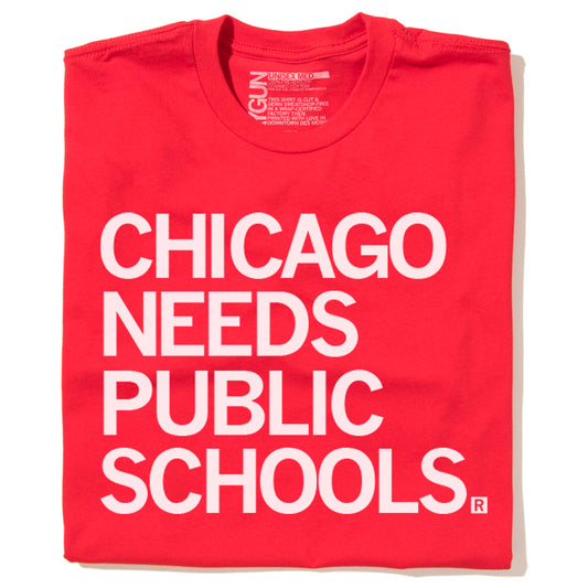 Red t-shirt with the white text CHICAGO NEEDS PUBLIC SCHOOLS. printed on the front, supporting public education.