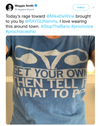 A person wearing a union labor blue t-shirt featuring a stylized uterus icon above the text: GET YOUR OWN THEN TELL IT WHAT TO DO.