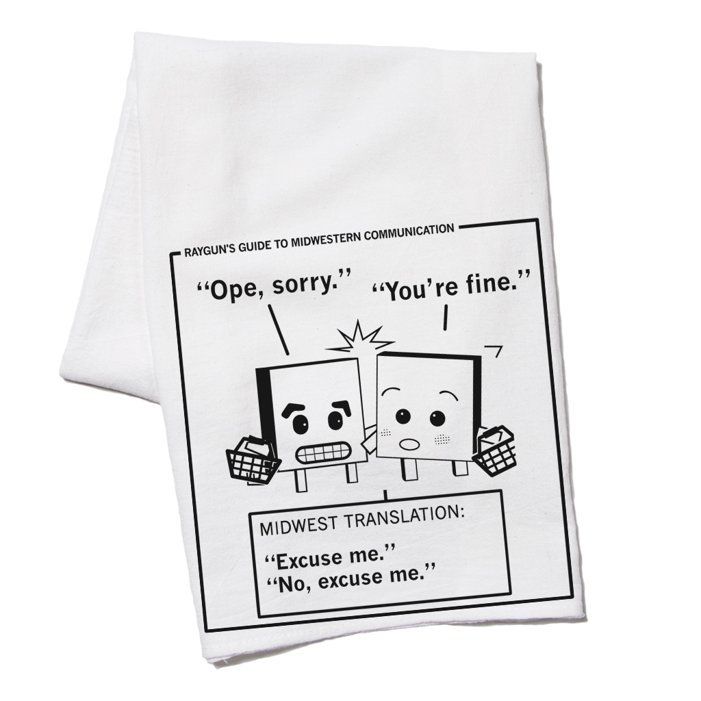 White RAYGUN kitchen towel featuring a cartoon titled Rayguns Guide to Midwestern Communication, showing two characters bumping into each other with the captions Ope, sorry and You’re fine, translated as Excuse me and No, excuse me.