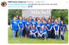 A large group of teachers posing in front of the Mitchell Early Learning Center sign, all wearing matching union made blue t-shirts that say America Needs Teachers to show their support for public education.