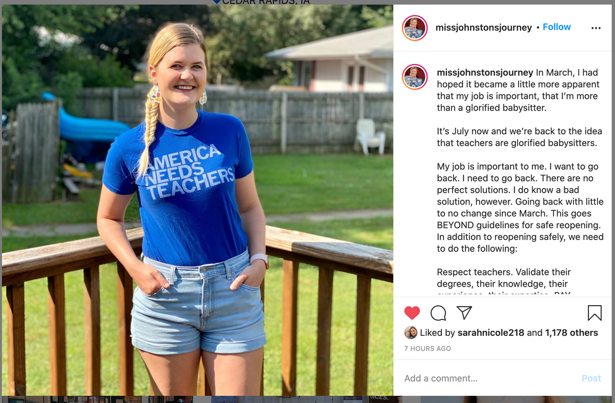 A smiling woman with a blonde side braid wears a blue America Needs Teachers shirt and light blue denim shorts while standing on a wooden deck, showing her support for public education.