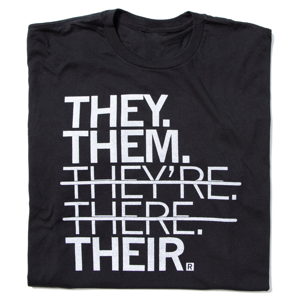 Black union made t-shirt with white text reading THEY. THEM. THEYRE. THERE. THEIR., featuring strikethroughs over THEYRE and THERE.