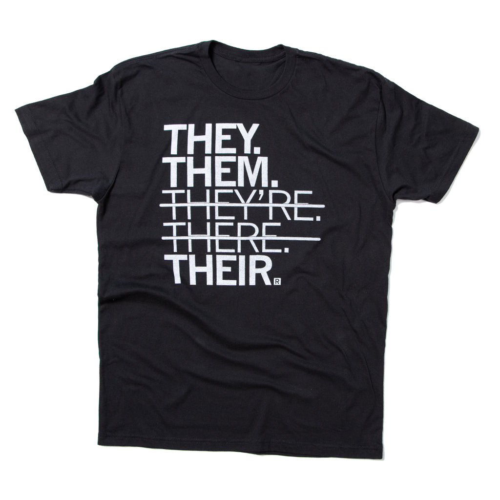 Black union made t-shirt with white text that reads THEY. THEM. THEYRE. THERE. THEIR., with a horizontal line striking through the words THEYRE and THERE.