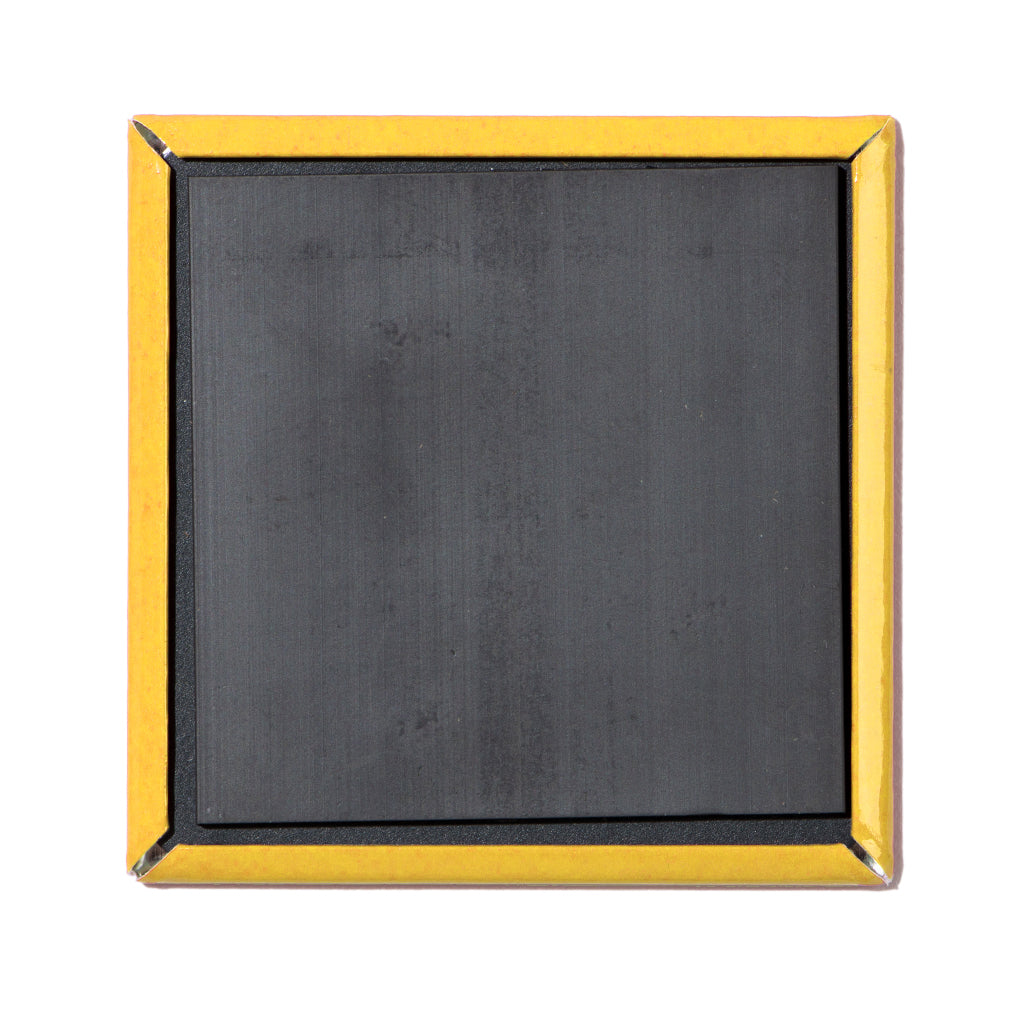 The back of a square Wisconsin magnet with a black magnetic surface and a yellow metal border.