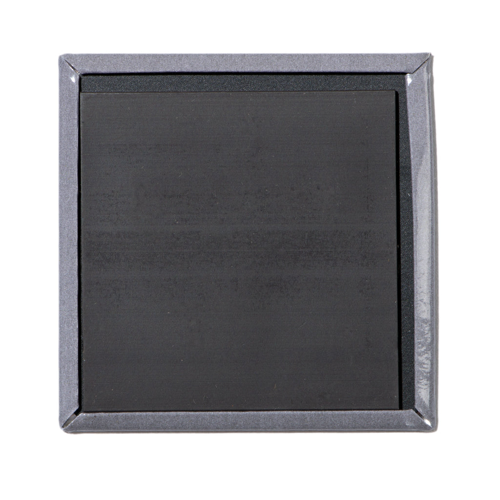 Back view of a square, metal magnet with a metallic grey border and a black magnetic surface.