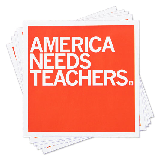 A stack of square, orange vinyl stickers with the white text AMERICA NEEDS TEACHERS.