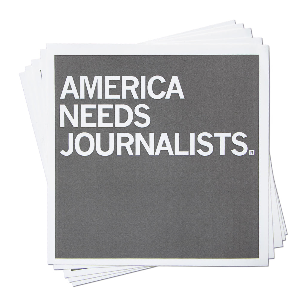 A stack of square vinyl stickers featuring the gray text AMERICA NEEDS JOURNALISTS.