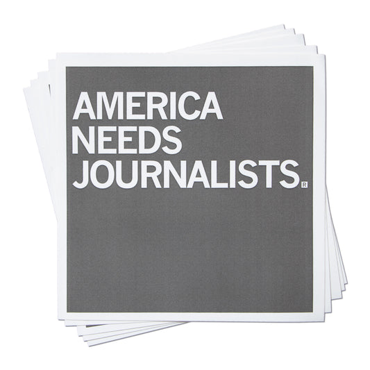 A stack of square vinyl stickers featuring the gray text AMERICA NEEDS JOURNALISTS.