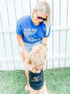 A smiling woman and her fluffy dog wearing matching RAYGUN dog shirts that say Ask me about my dog’s Instagram.