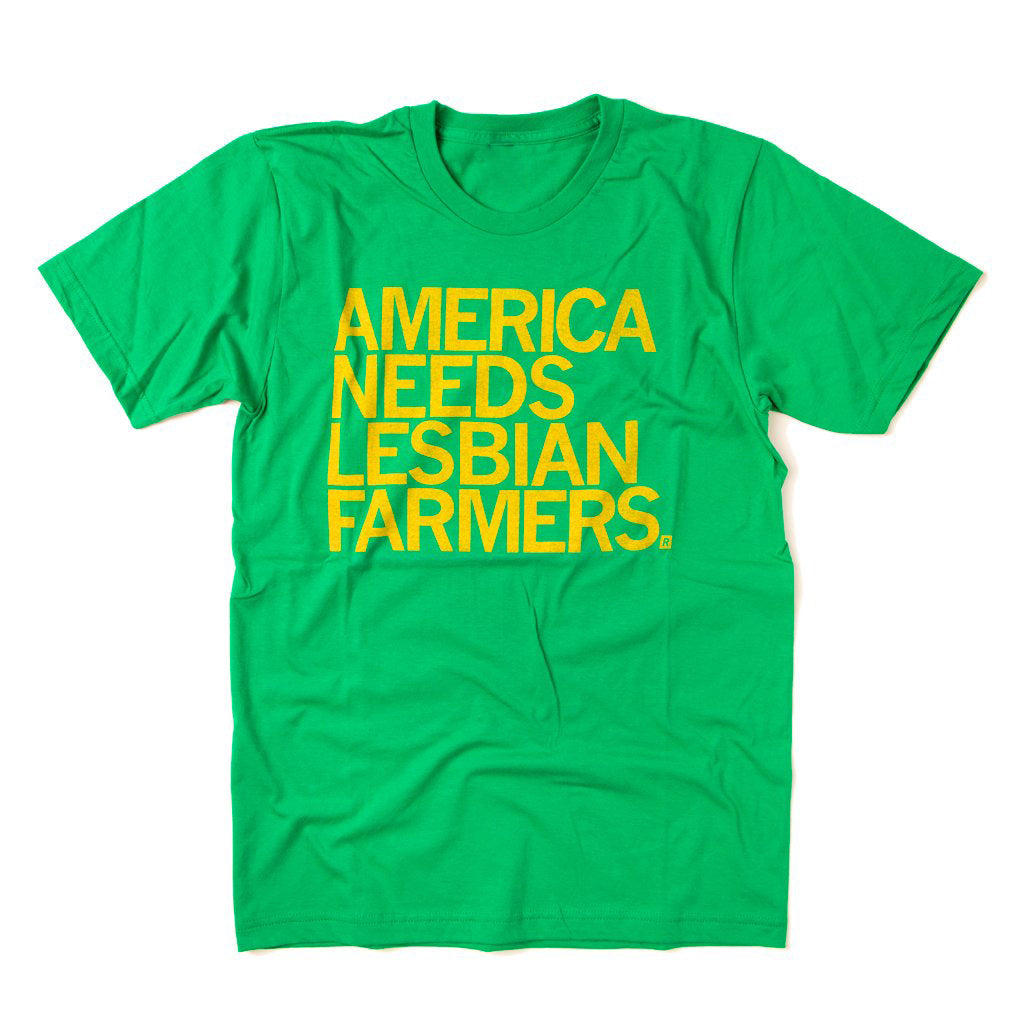 Kelly green shirt with gold ink that says, "America Needs Lesbian Farmers" in all caps.