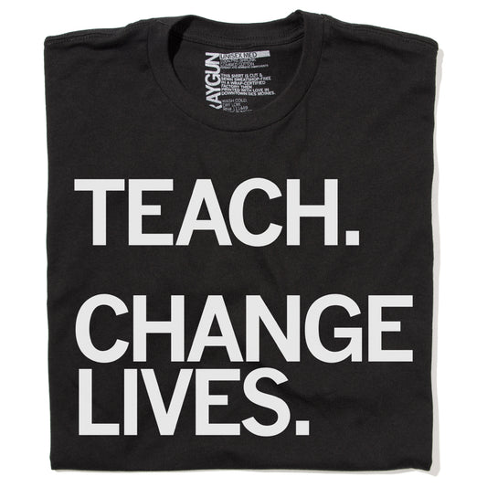 A folded black, union-made T-shirt with the white text TEACH. CHANGE LIVES. printed on the front.