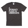 Charcoal t-shirt with left aligned white ink that reads "A Woman's Place Is In Charge"