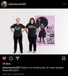 Two women stand next to a large graphic of a girl with an afro raising her fist, captioned The potential to all girls. They wear union made shirts reading Vote and A woman’s place is in charge, promoting women’s empowerment.